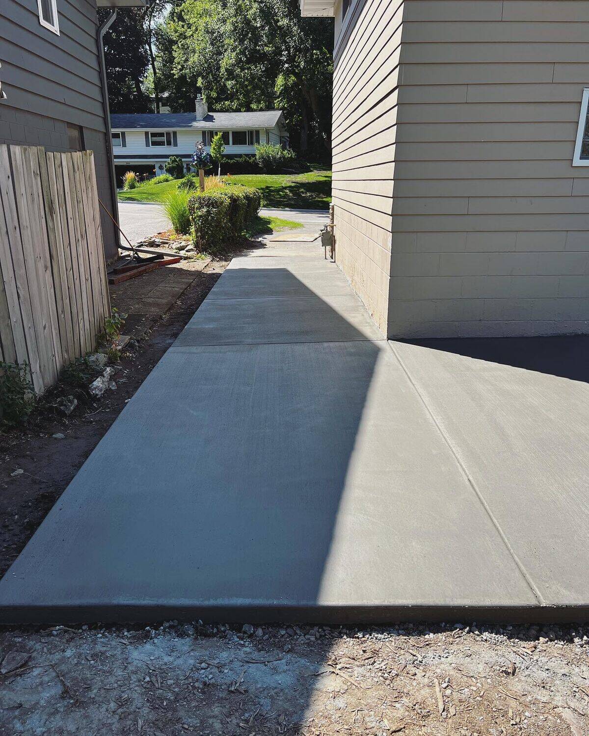 Straight broom-finish concrete sidewalk with uniform surface and clean joints