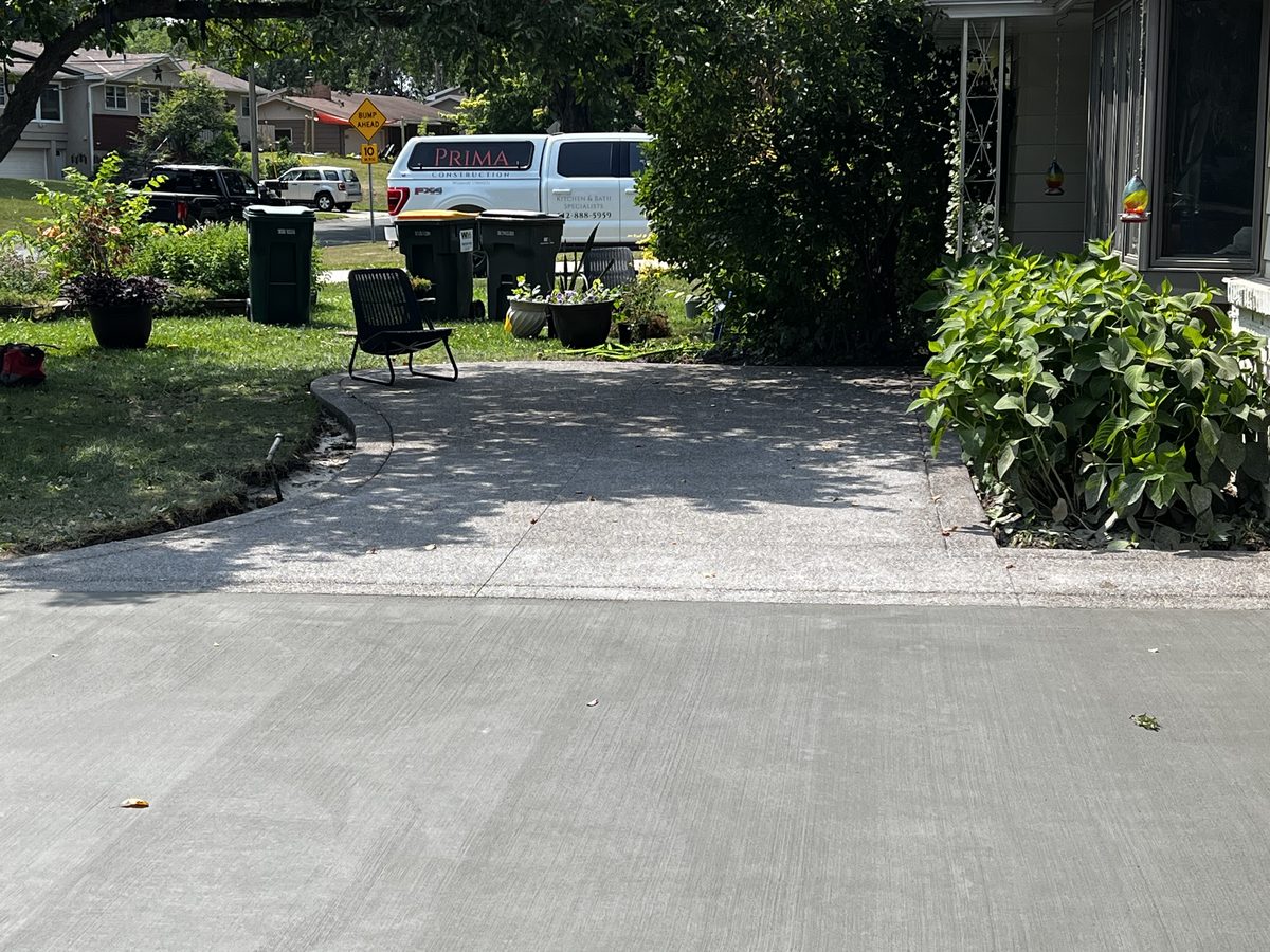 Concrete driveway and parking pad finished beside a home in Columbia Heights, MN
