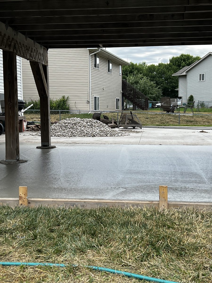 Concrete slab poured beneath an elevated deck with forms still in place